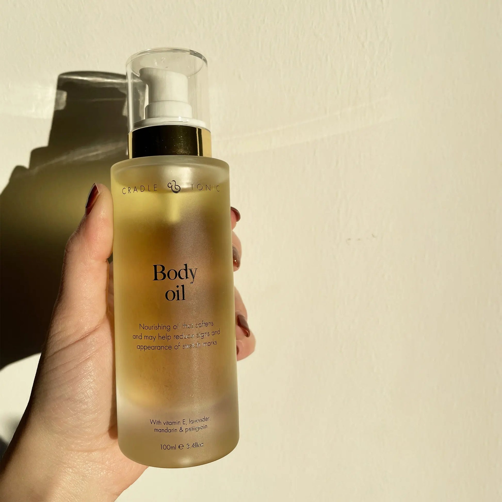 Pregnancy Stretch Mark Oil | Natural Body Oil for Bump Care in a frosted glass pump bottle with gold accents, ideal for hydrating and reducing stretch marks.